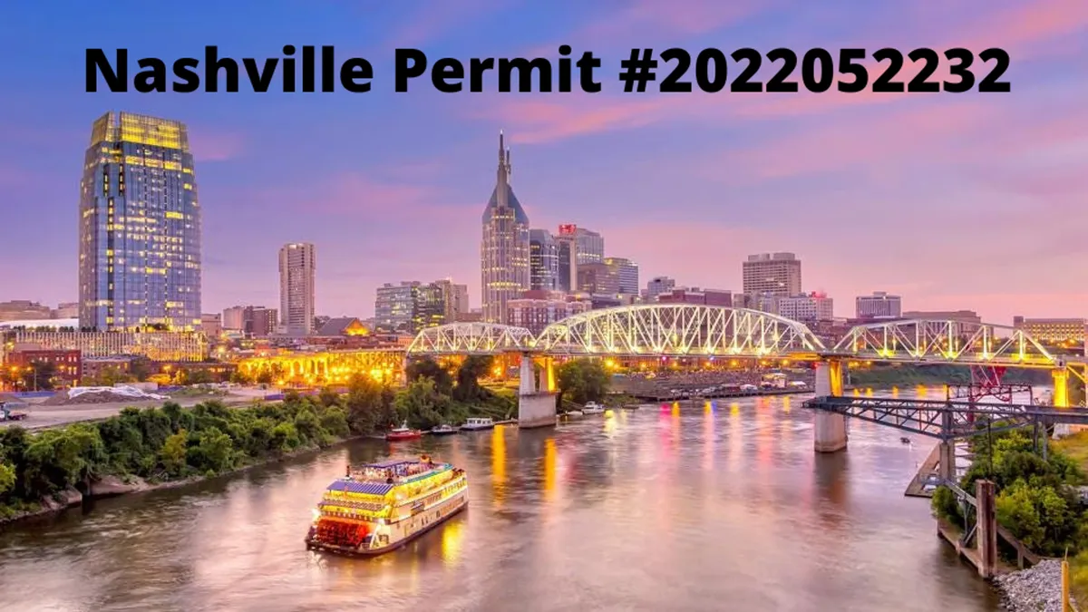 A wide exterior view of the Nashville skyline at dusk, with the river in the foreground and a riverboat cruising along. City lights begin to twinkle as evening falls, highlighting the city’s lively nightlife and scenic beauty.