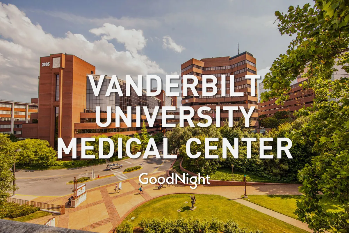 This exterior image features the Vanderbilt Medical Center building surrounded by a well-maintained garden and walkway, creating a sense of tranquility and approachability. The setting is conducive to both short walks and outdoor relaxation, which appeals to those seeking a supportive environment during medical or business stays.